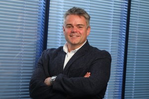 Dr Neil O'Brien standing arms crossed.