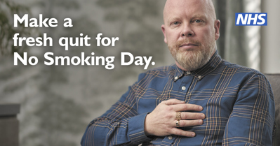 Man looking at camera holding chest