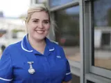 A young female nurse smiling at the camera