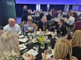 A group of people having a table discussion at an event