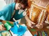 An adult female with a young child doing art and crafts