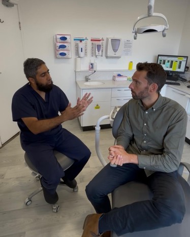Dentist and MP talking in dental room