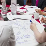 Someone writing down ideas during a focus group