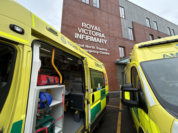 Picture of ambulance van with door open outside hospital