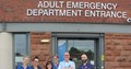 Six health professionals stood outside emergency department